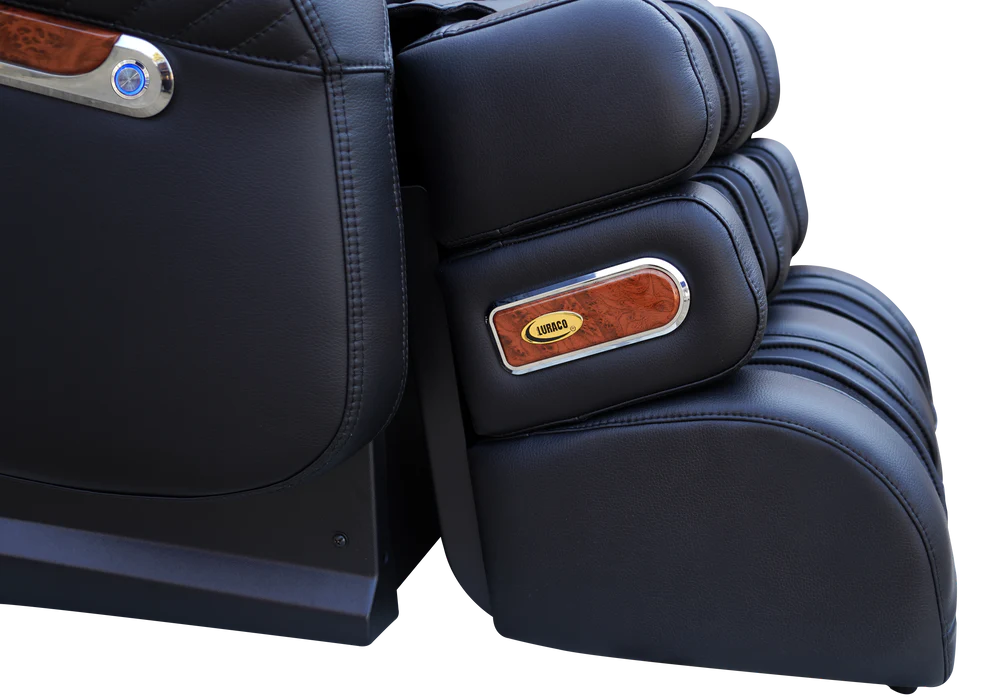 Close-up of a black massage chair showing the side and footrest area with wood trim and a visible Logitech brand badge.
